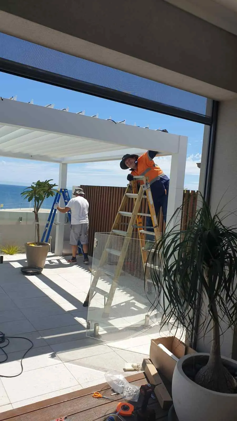 Die Arbeiter befolgten den Ablauf beim Aufbau des Sonnenschutzes.