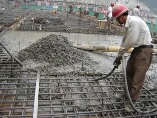 Workers are pouring concrete.