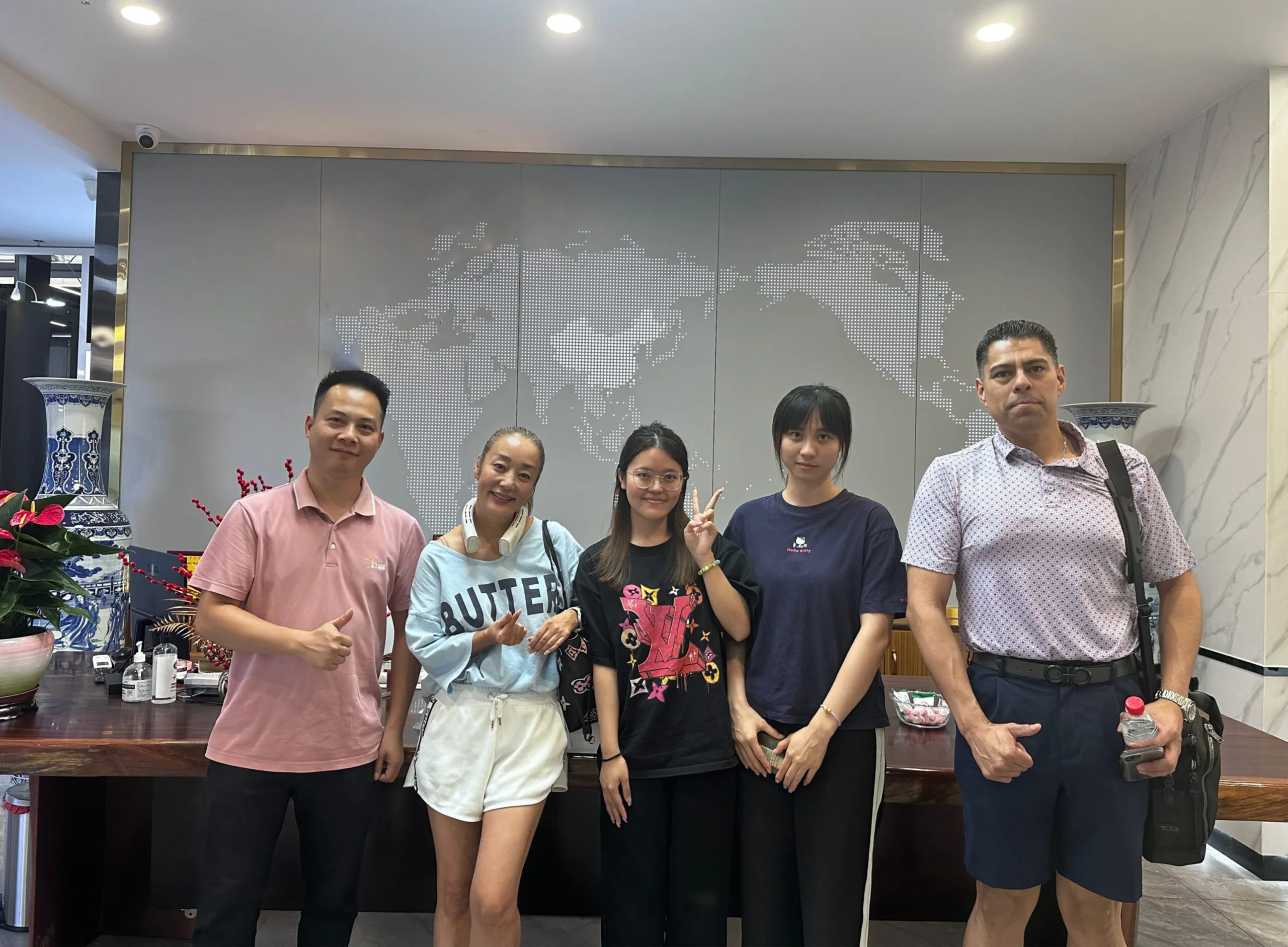 Kitty, a salesperson at Progolas & Aprodoor, and a client in front of the office