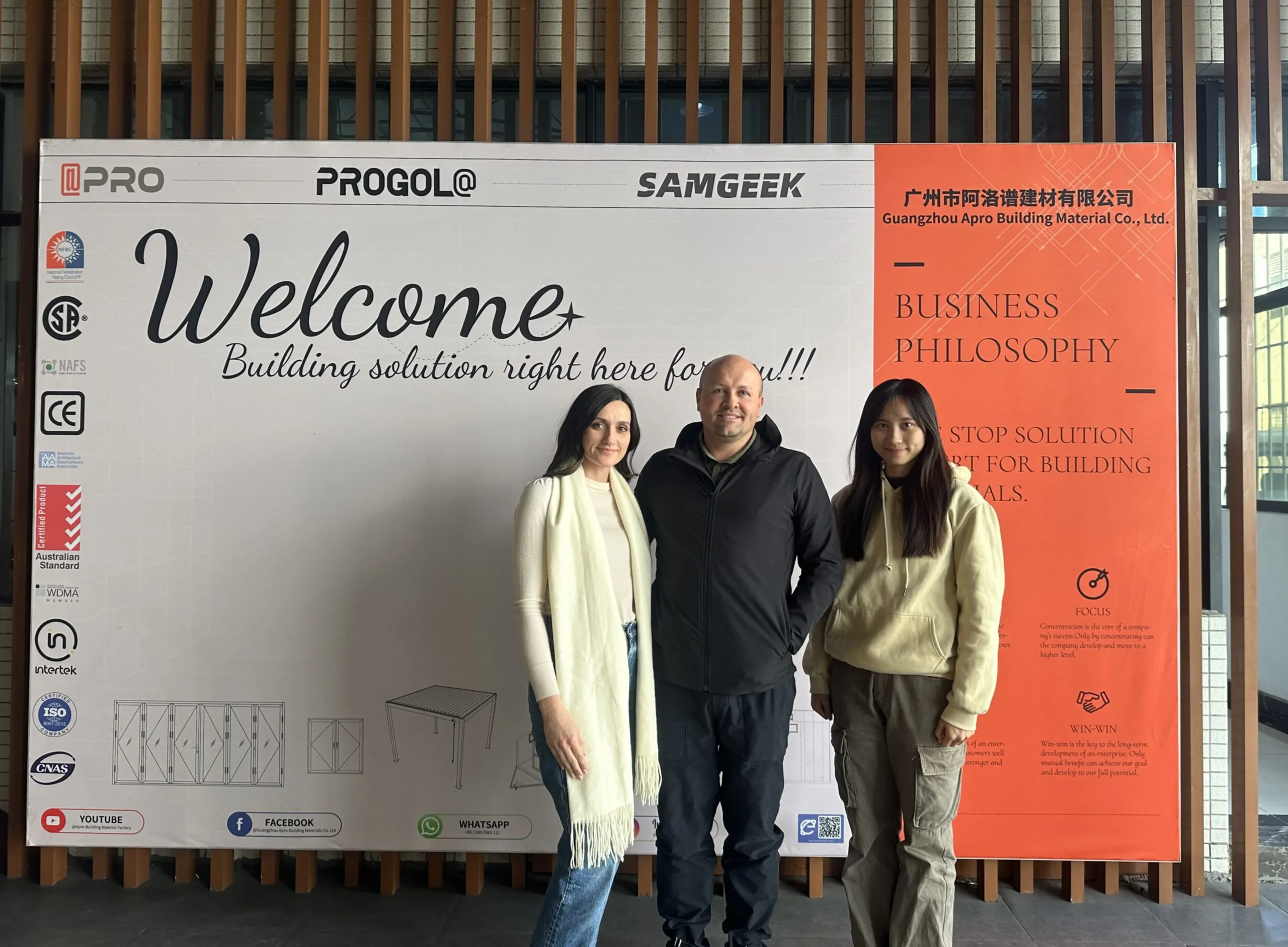 Progolas salesperson Kitty takes a photo with an American customer in front of the company's billboard